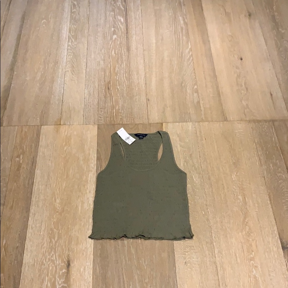 Green sleeveless form fitting tank w/ ruffled edge
